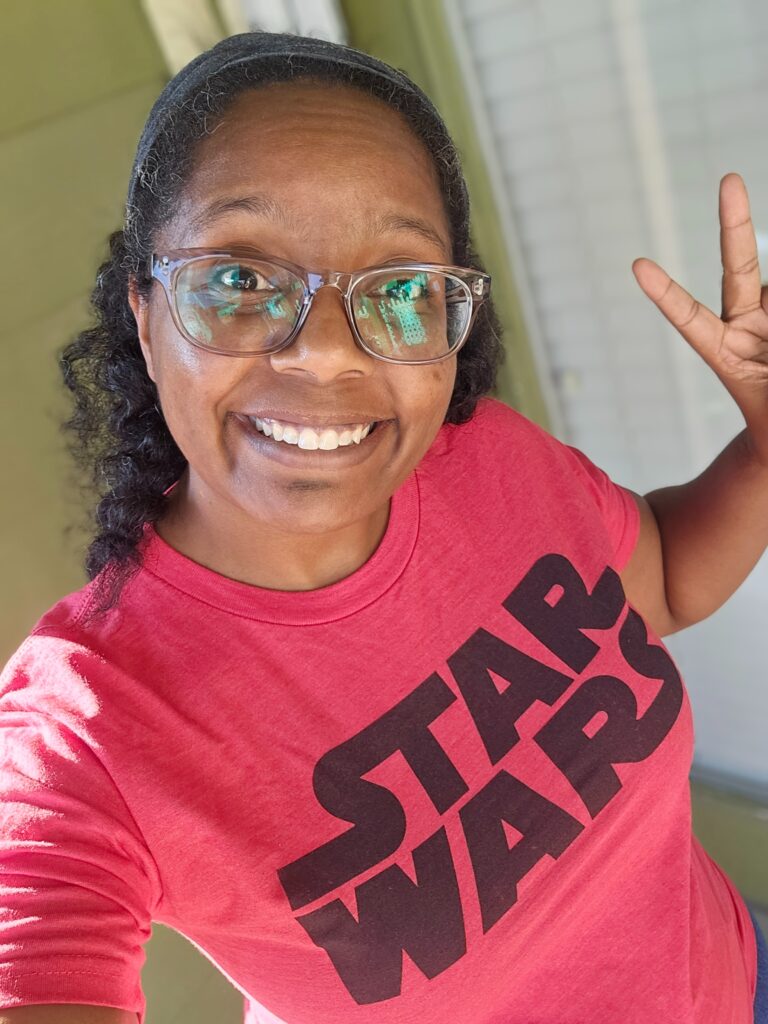 woman wearing red Star Wars shirt with peace sign