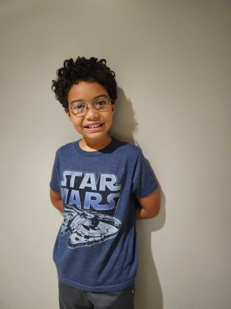 Boy in a blue star wars shirt