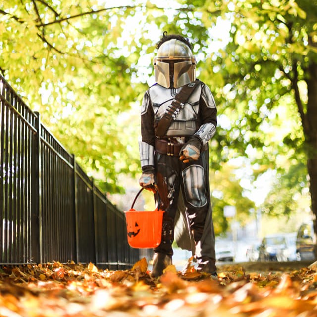 boy in a Mandalorian costume around Halloween time